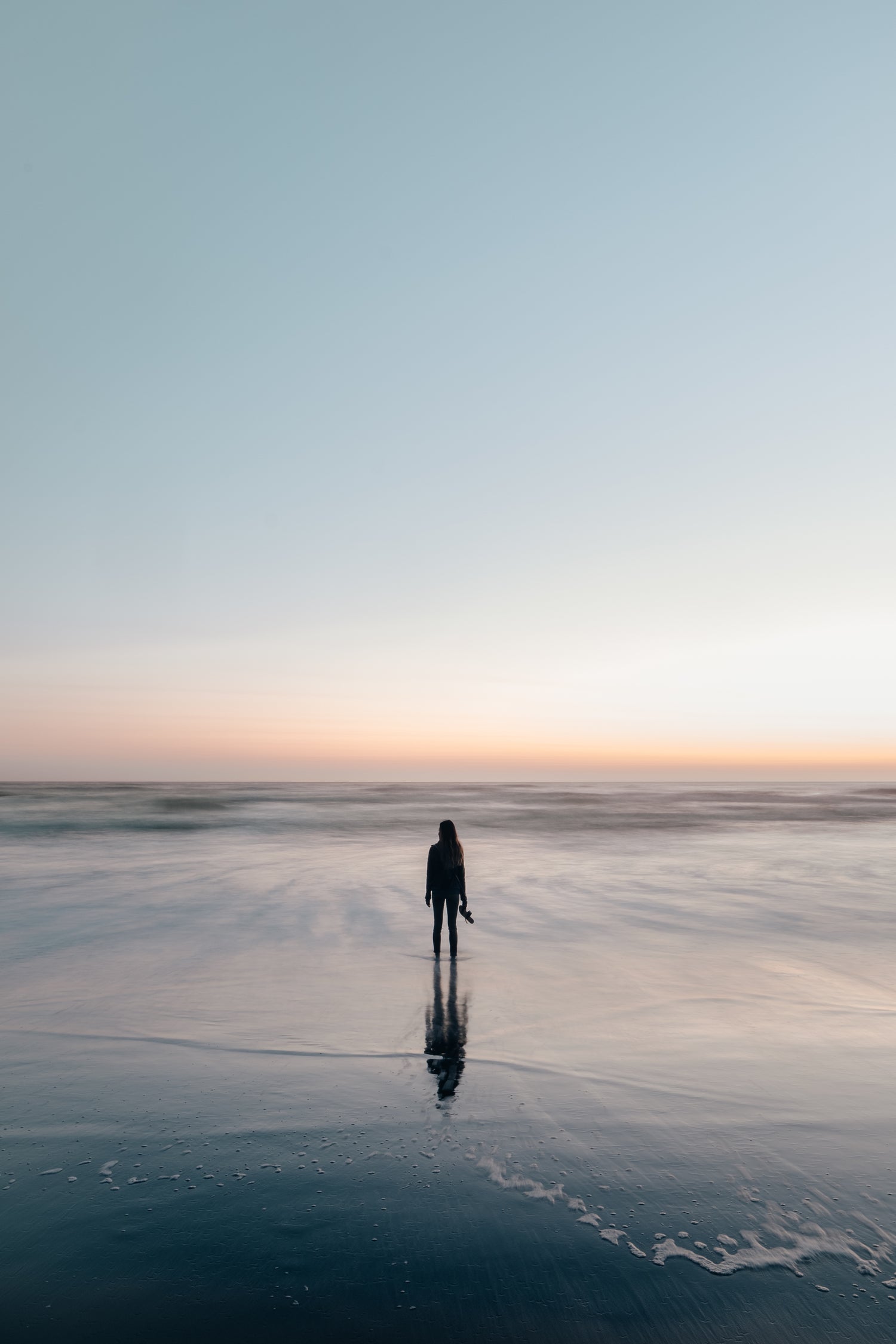 Woman on beach at sunset